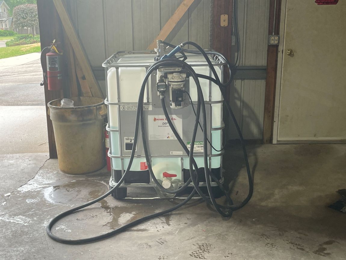 A large container with a hose attached to it