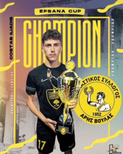 Man holding trophy, champion title with yellow text.  Aris Voulas team logo and EPSANA CUP banner.