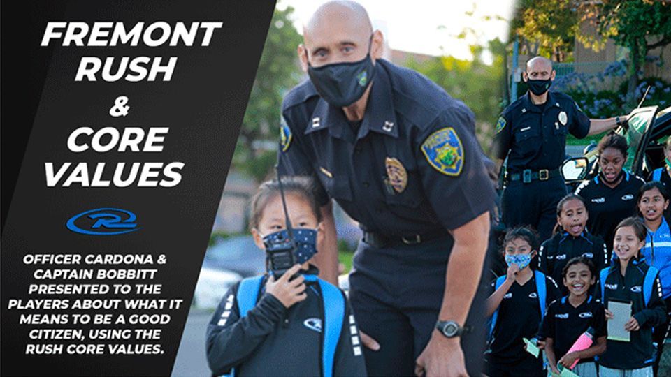 Fremont Rush soccer players with police officers, learning about core values. Officer Cardona and Captain Bobbett presented.
