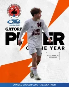 A soccer player with the number 14 on his shirt