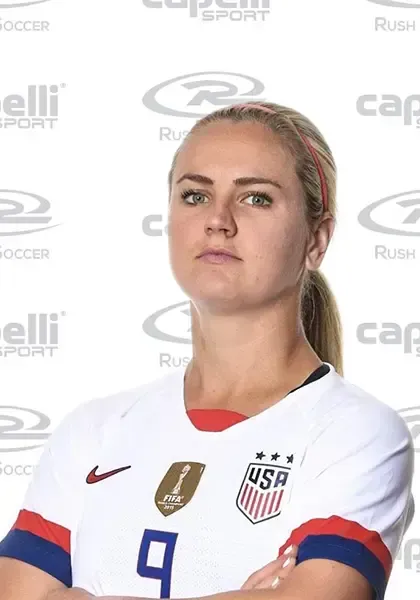 Lindsay Heaps in a USA jersey, arms crossed, looking forward.