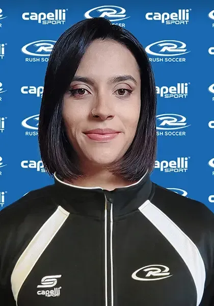 Woman with dark hair, wearing a black and white athletic jacket, smiling, in front of a blue background with logos.