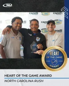 Three men holding an award labeled 