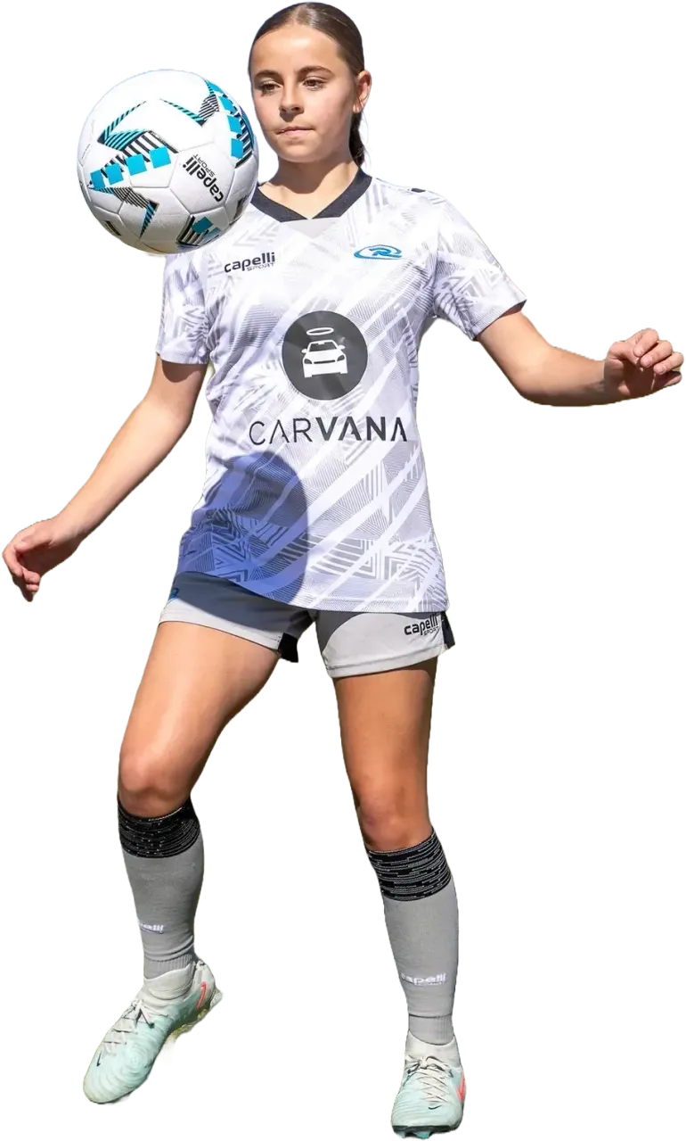 Soccer player in white jersey, using her head to control a ball. Outdoors, sunny day.