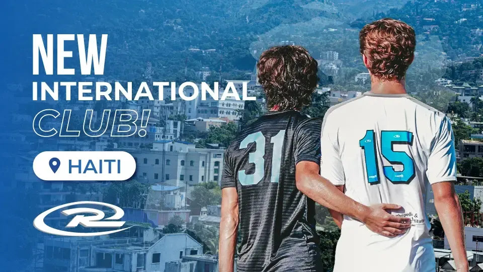 Two soccer players with their arms around each other, overlooking a cityscape in Haiti. New international club announced.