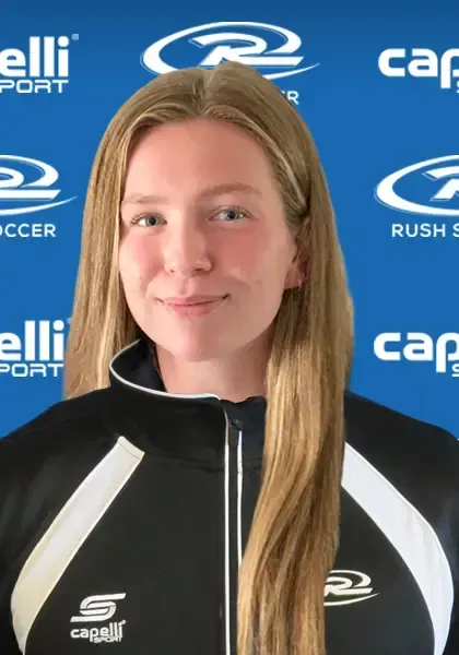 Woman with long blonde hair wearing a black and white athletic jacket. Blue background with logos.