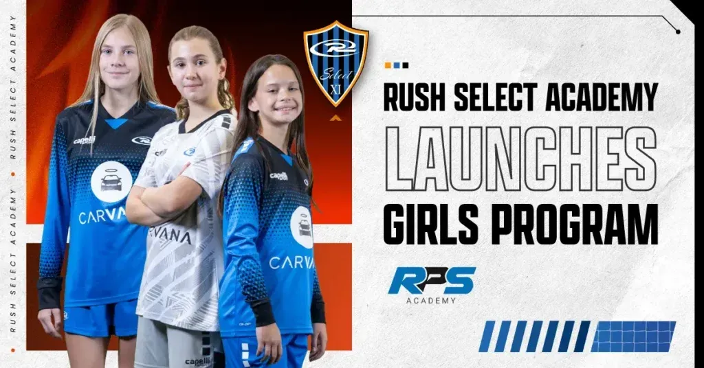 A group of young girls are standing next to each other in soccer uniforms.