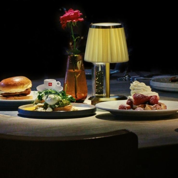 square image of a table with plates, food and vase