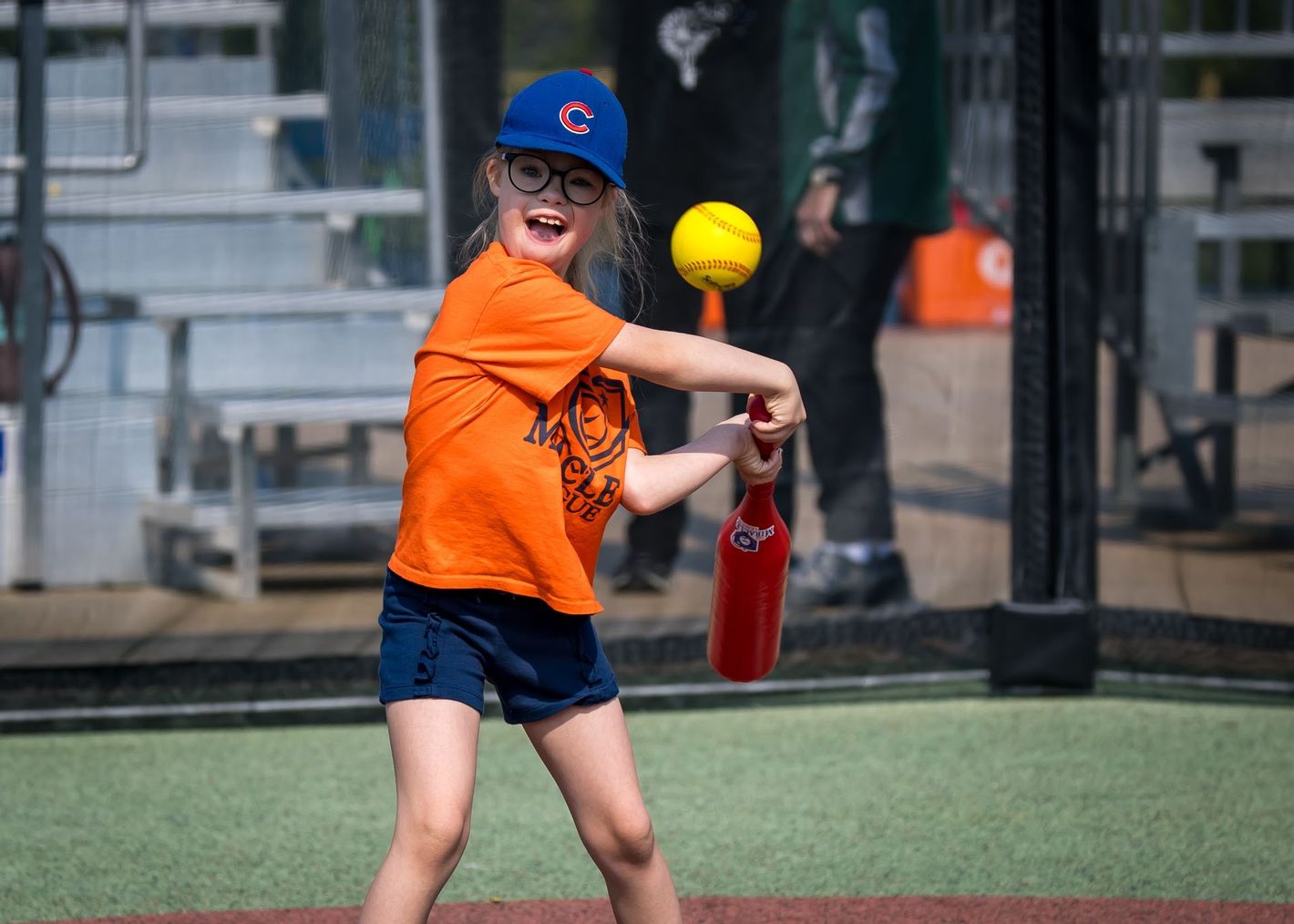 Baseball player sliding into base as another player attempts to catch the ball.