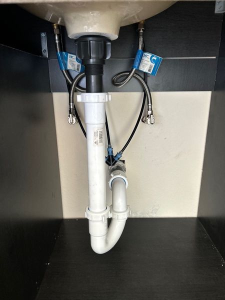 Pride Plumbing, Inc | A sink with a plumbing pipe underneath it