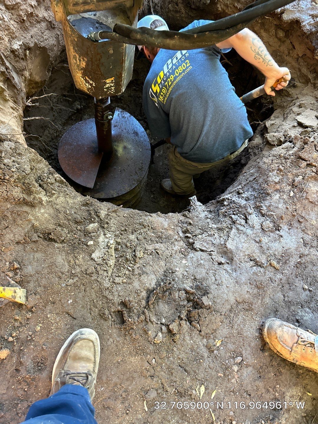 Pride Plumbing, Inc | A man is digging a hole in the ground with a machine.