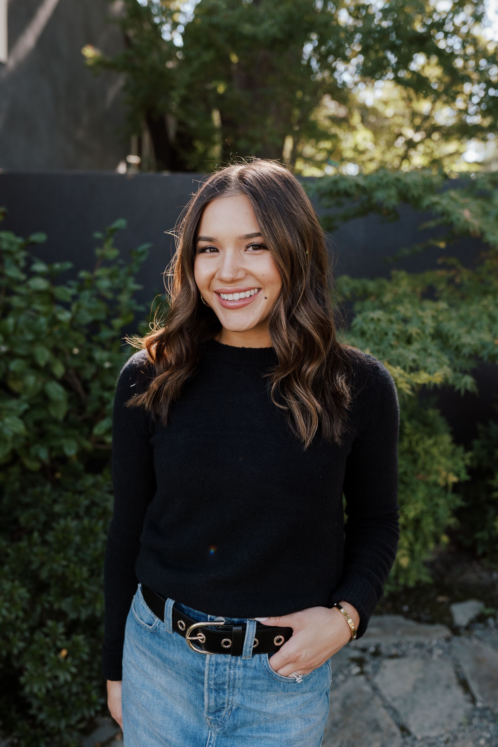 Tayler Smith wearing a black sweater and standing in front of a bush | Realtor in Greenhaven-Pocket, Sacramento, CA