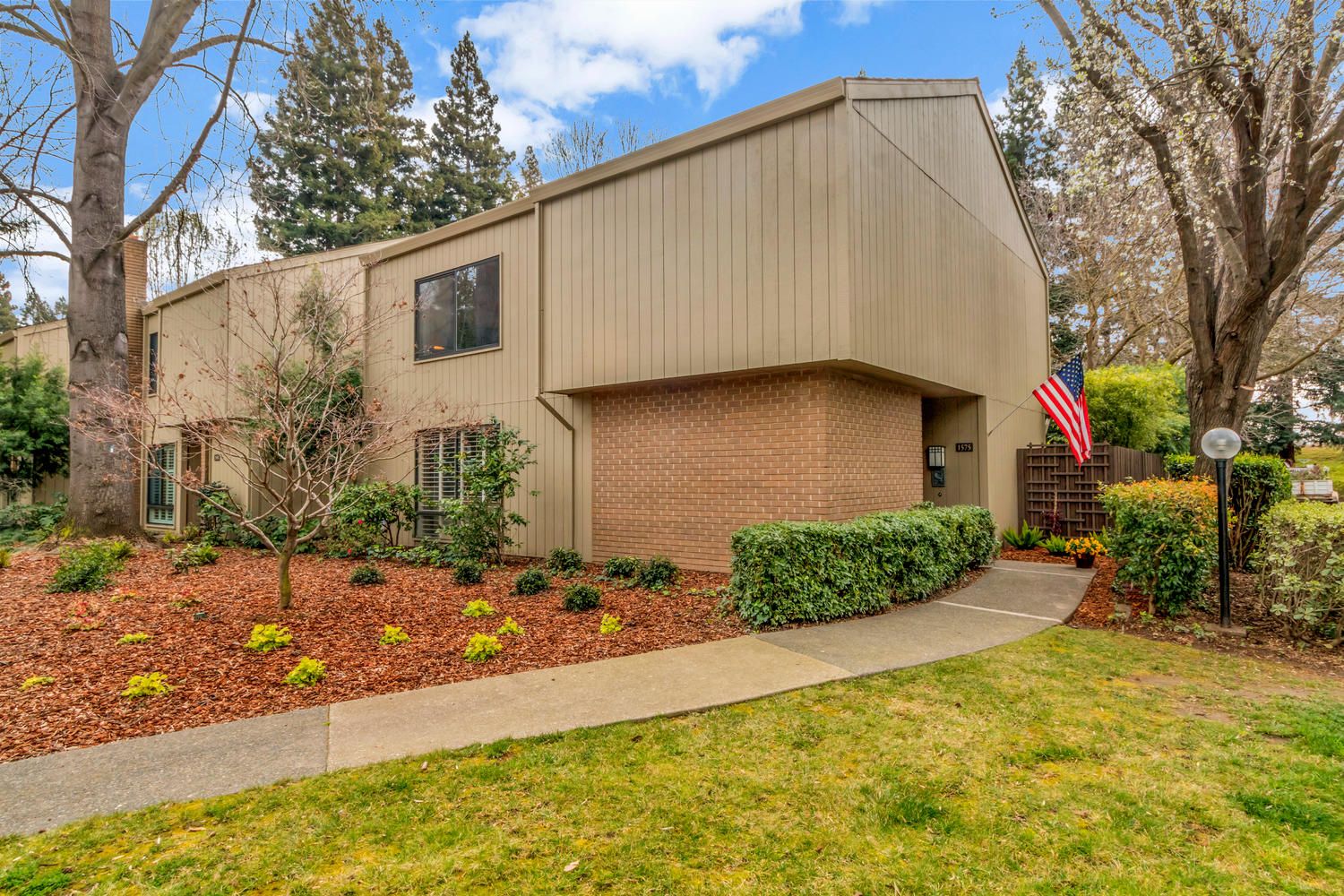 Large House with a flag & a large lawn in front. Find Homes for sale in Greenhaven-Pocket,Sacramento, CA with Renee Catricala