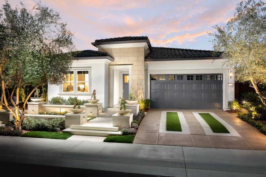 A large white house with a black garage door and a driveway | Sell a Home in Greenhaven-Pocket, Sacramento, CA