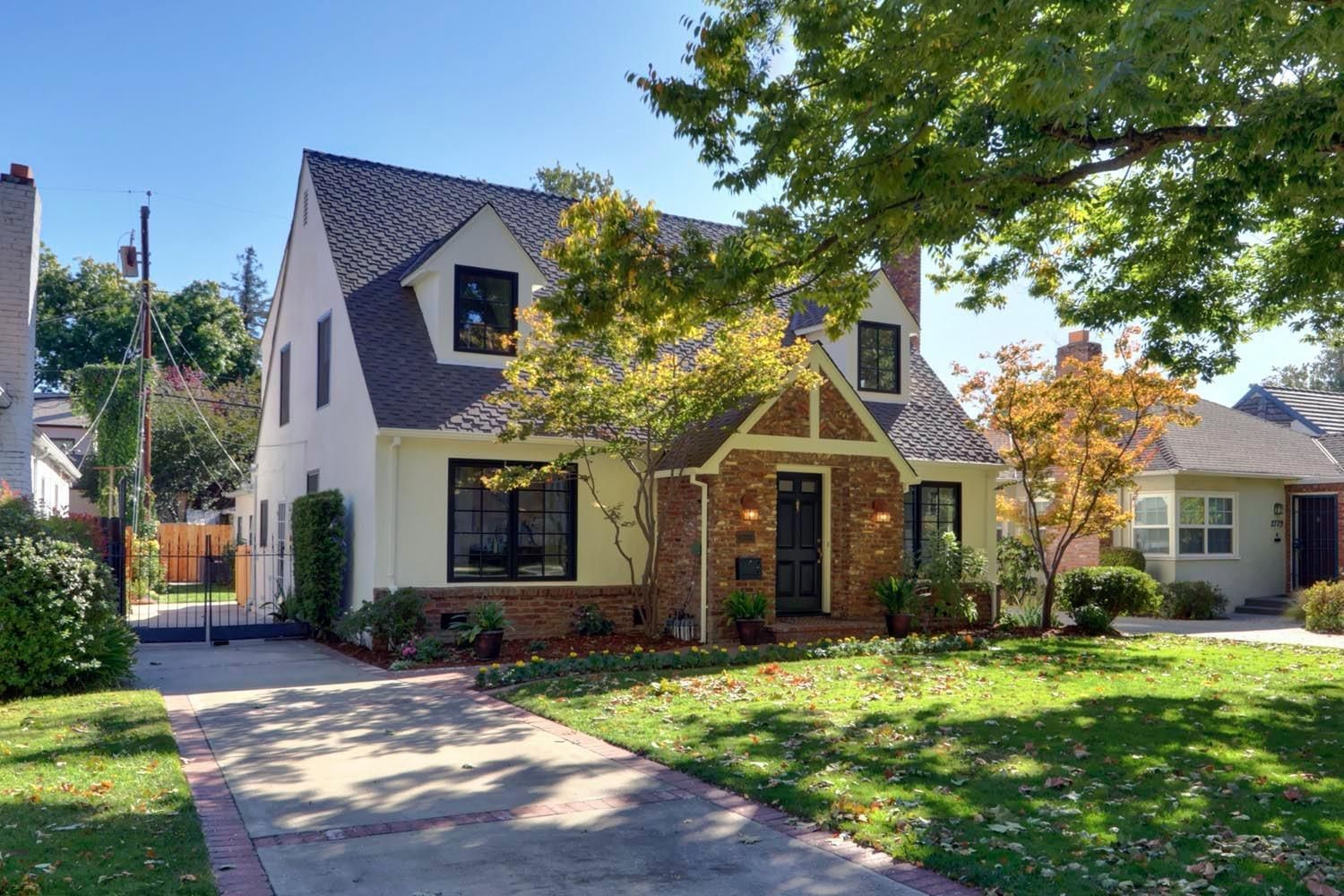 A white and brick house with a driveway leading to it | Sell a Home in Greenhaven-Pocket, Sacramento, CA