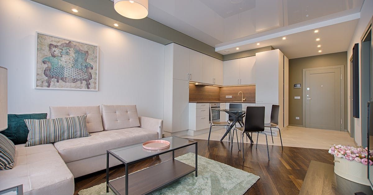 A living room with a couch , coffee table , and chairs.