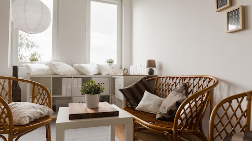 A living room with a couch , chairs , and a table.