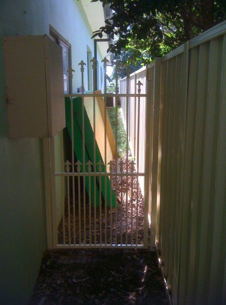 A Fence With a Gate Leading to a House — A&H Fences In Bowral, NSW