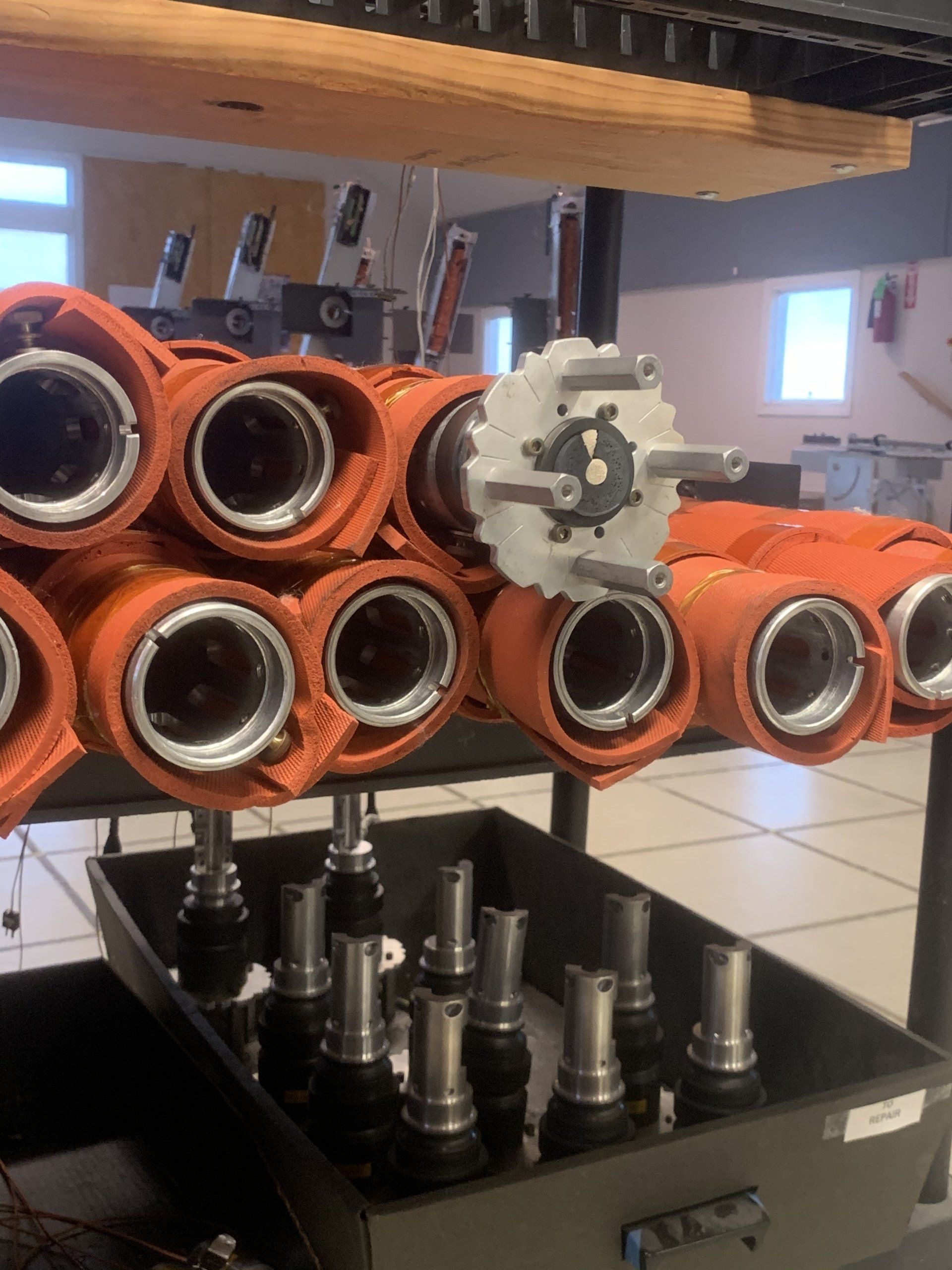 A bunch of orange pipes are stacked on top of each other
