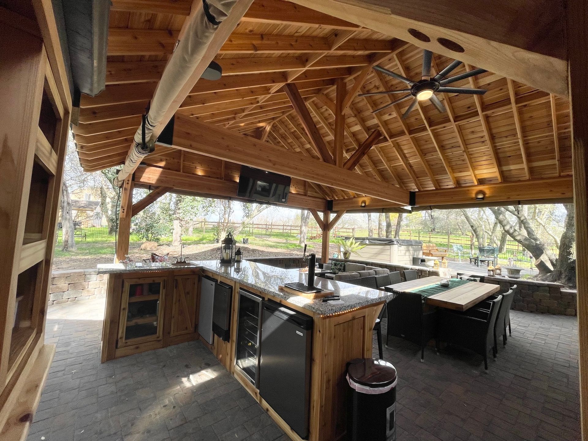 A kitchen with a large island and a ceiling fan