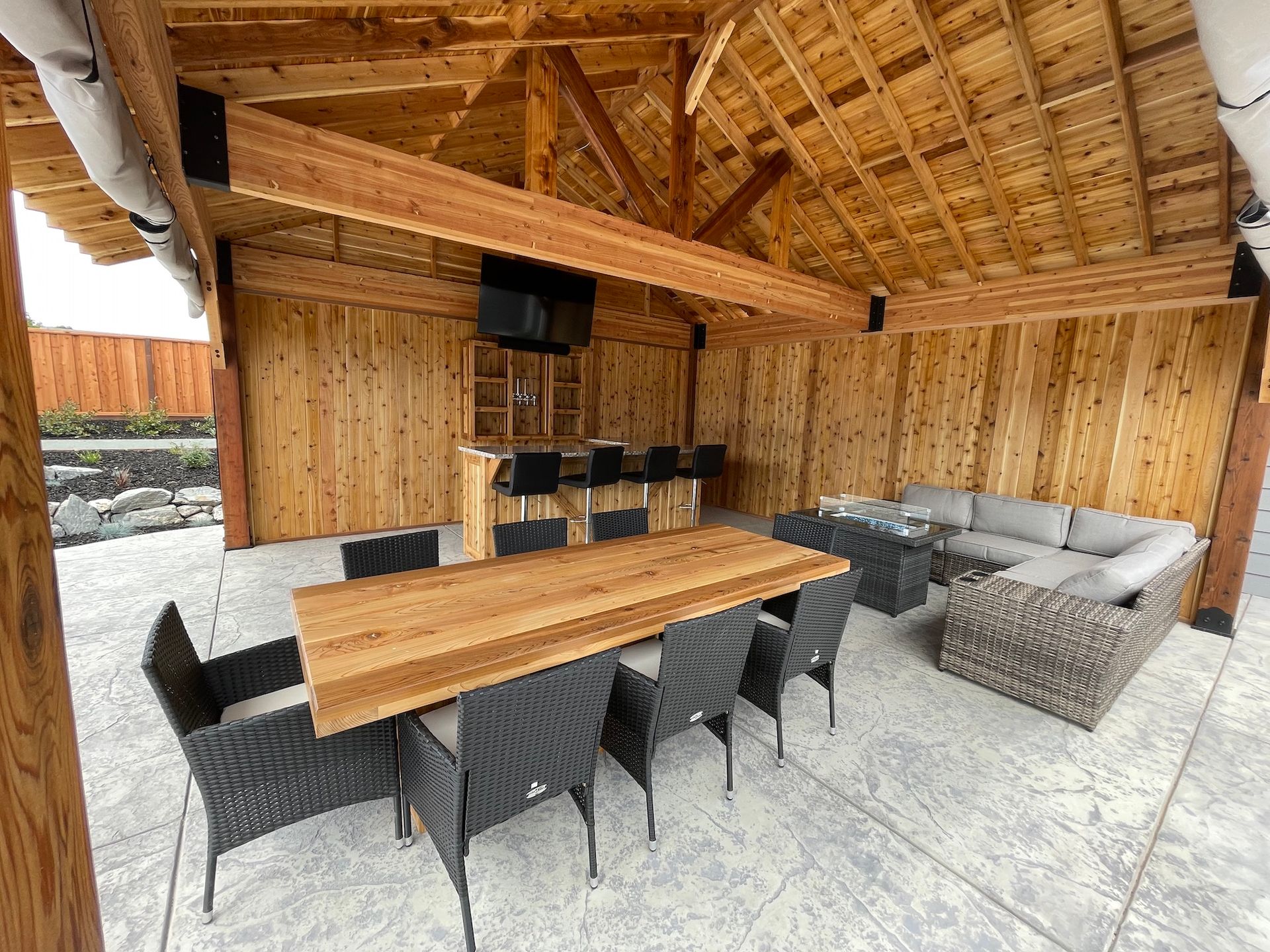 There is a table and chairs in the middle of the room.