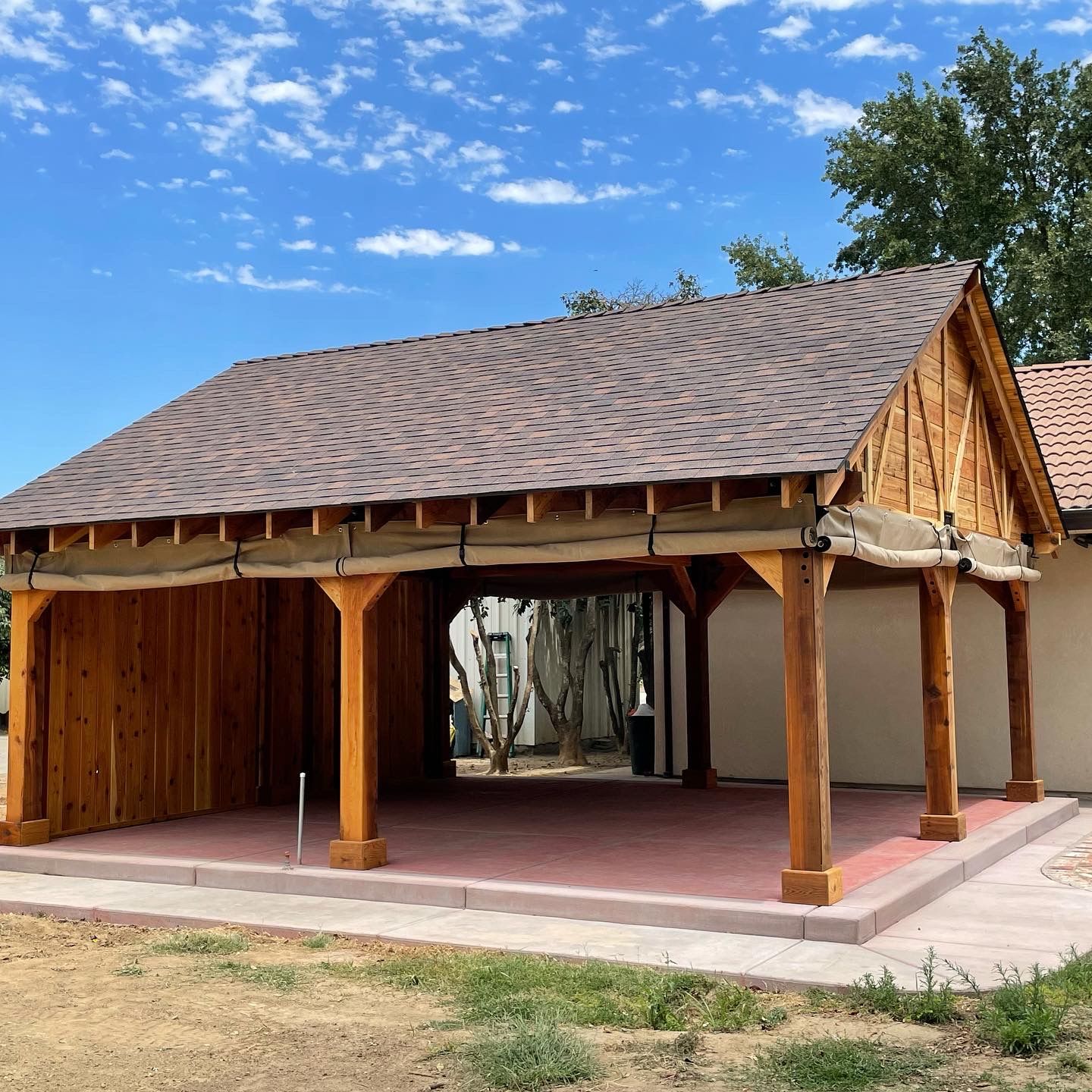 A wooden pavilion with a roof that has shingles on it