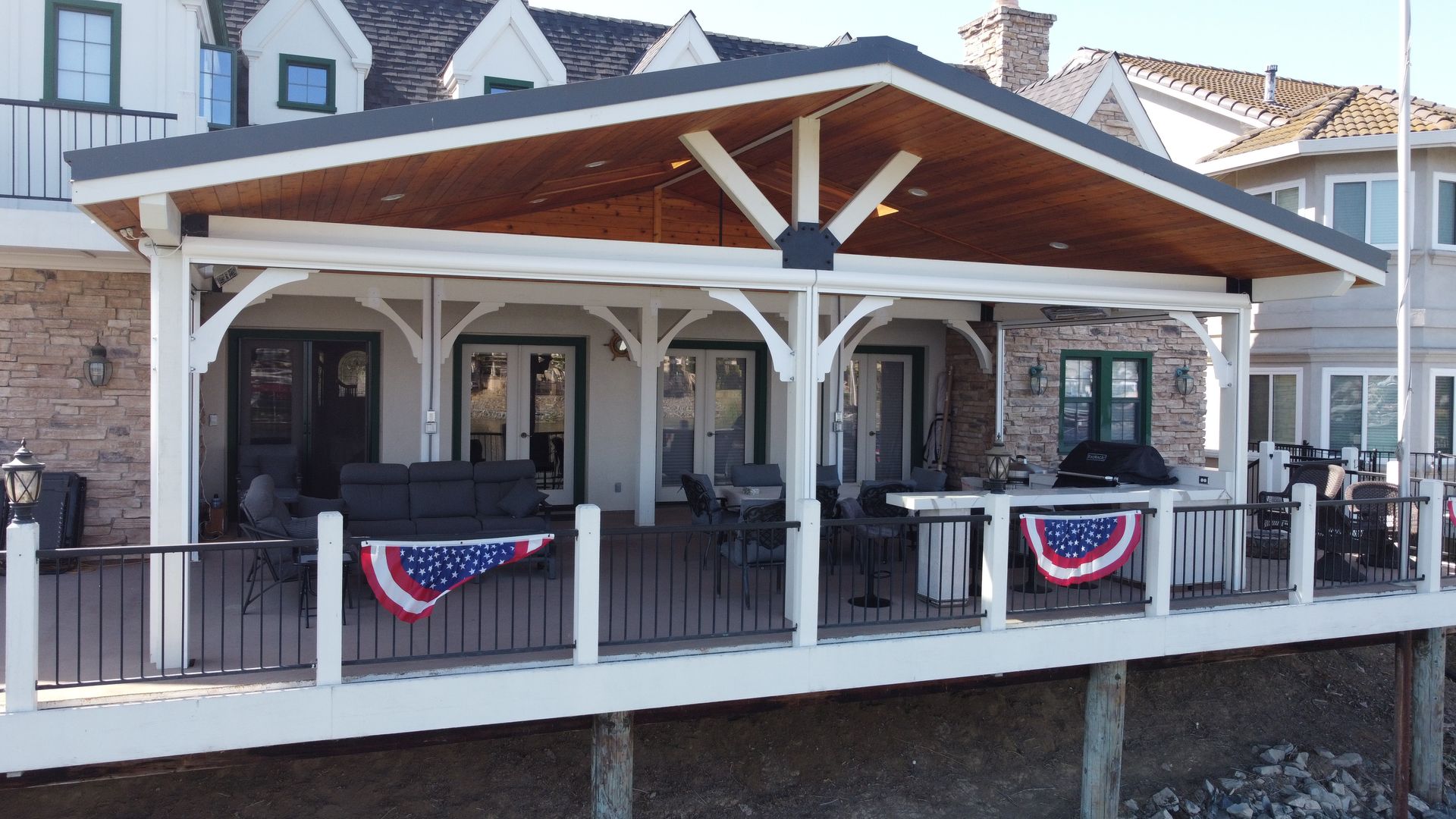A large house with a large deck and a covered porch
