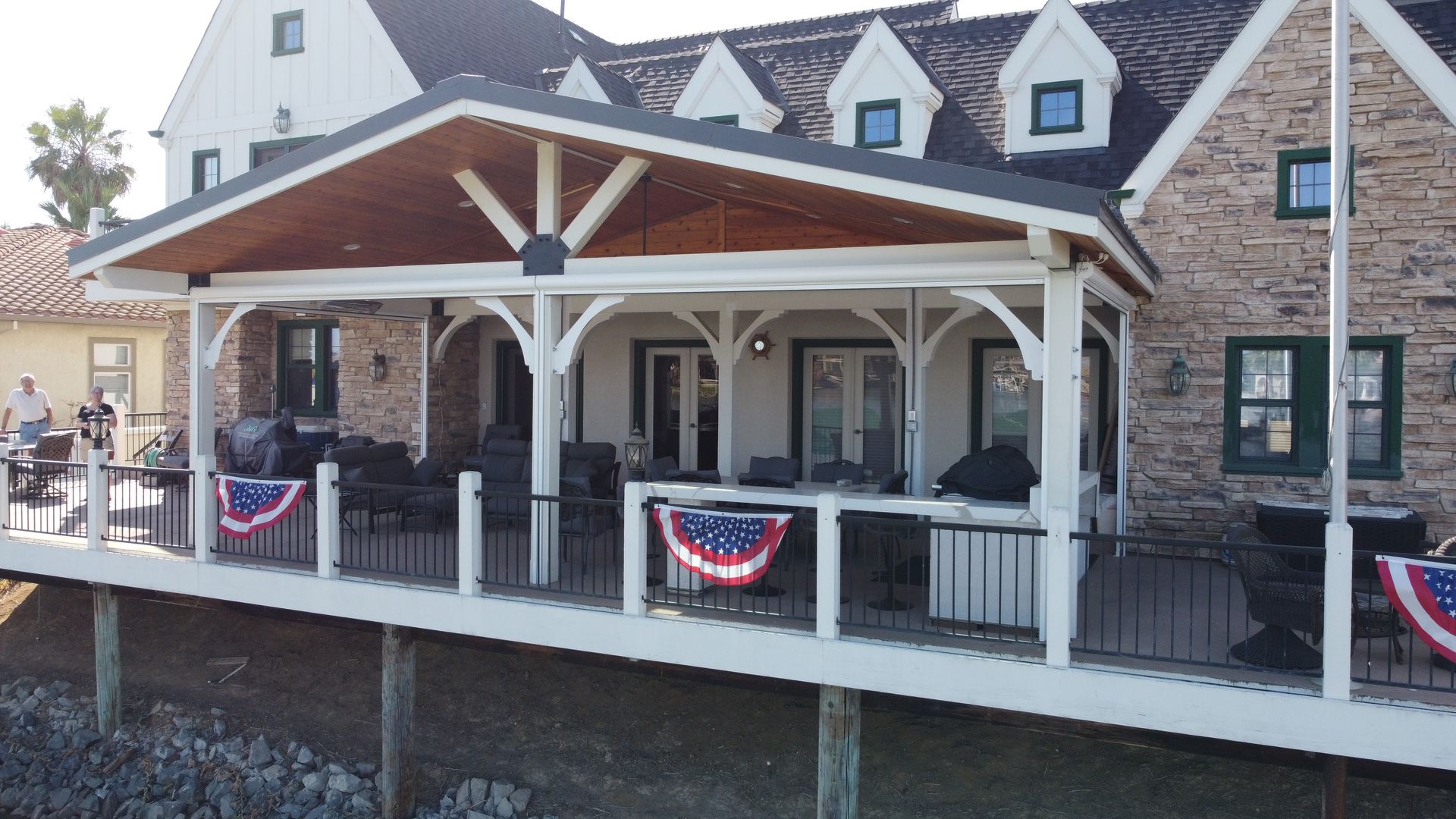 A large house with a large porch and a flag on it