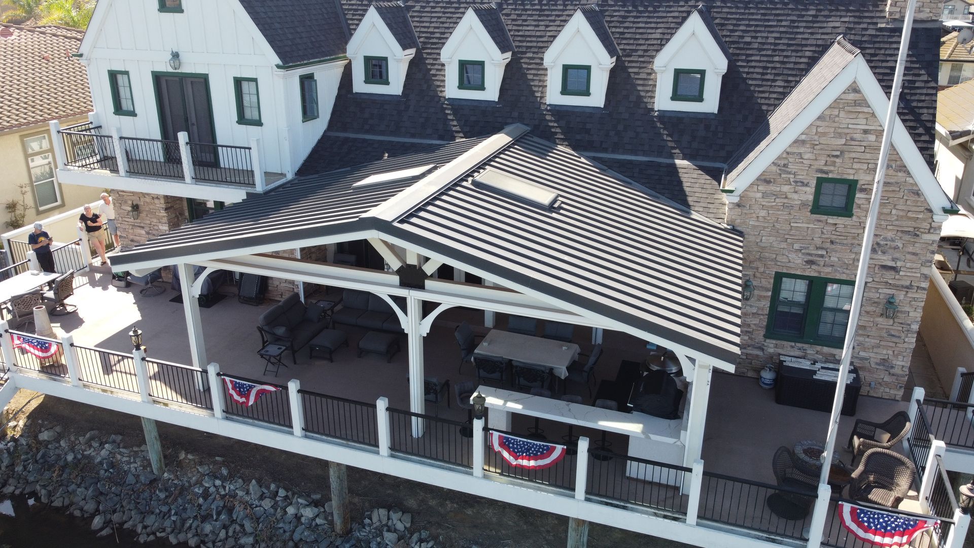 An aerial view of a large house with a covered patio