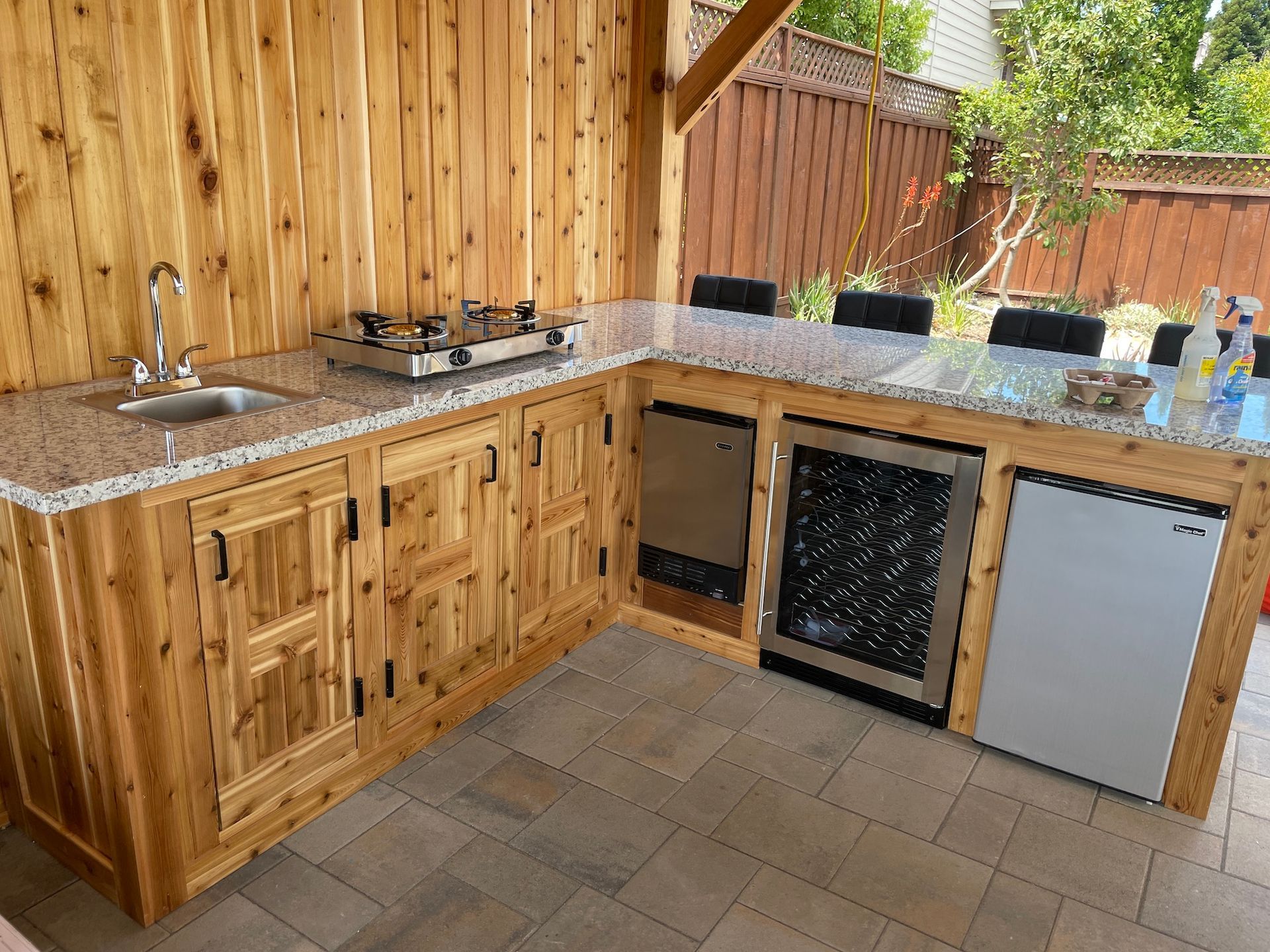A kitchen with a sink , stove , dishwasher and refrigerator.