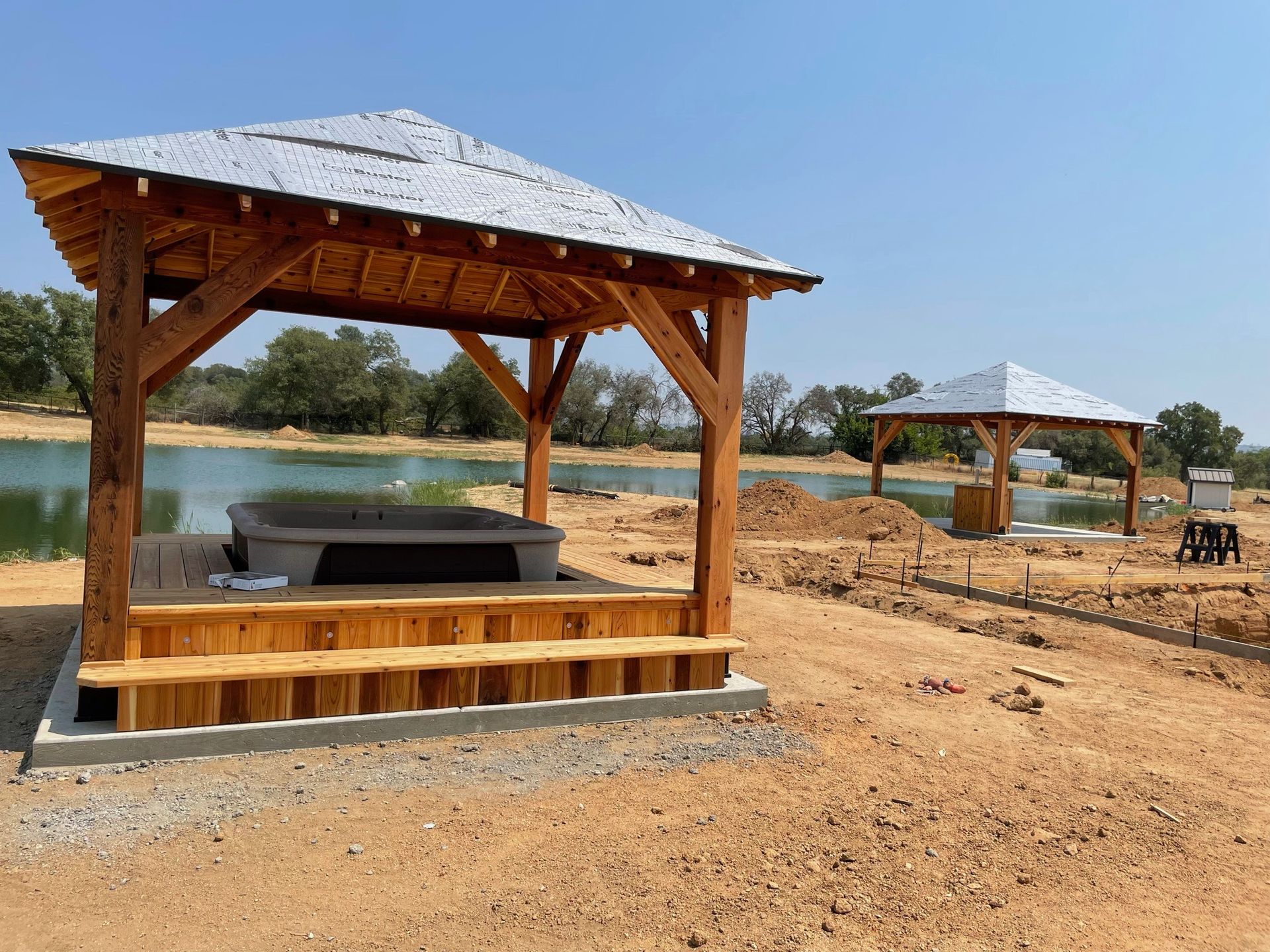 There is a pavilion with a hot tub underneath it.