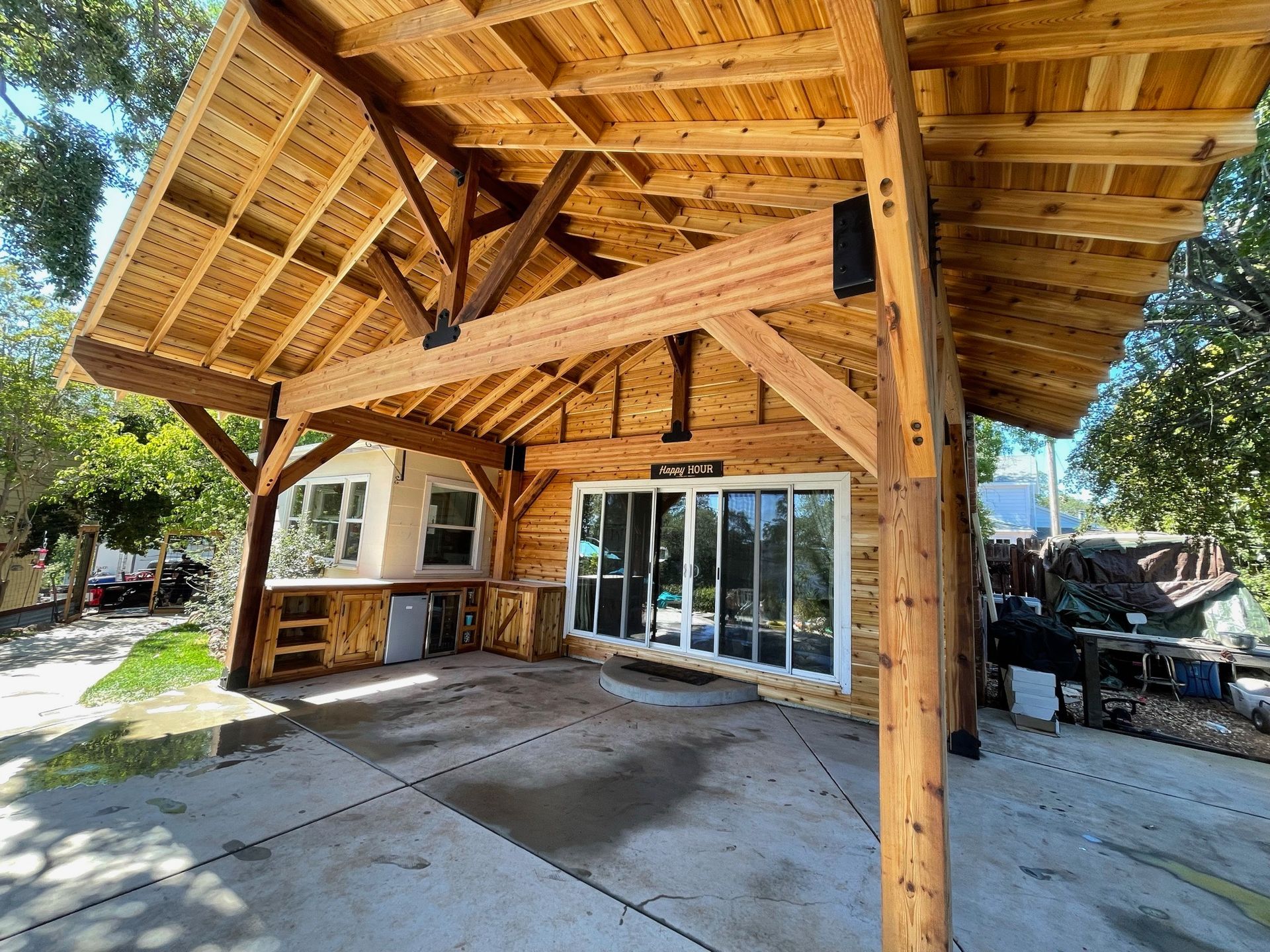 A wooden structure with a roof and a lot of windows