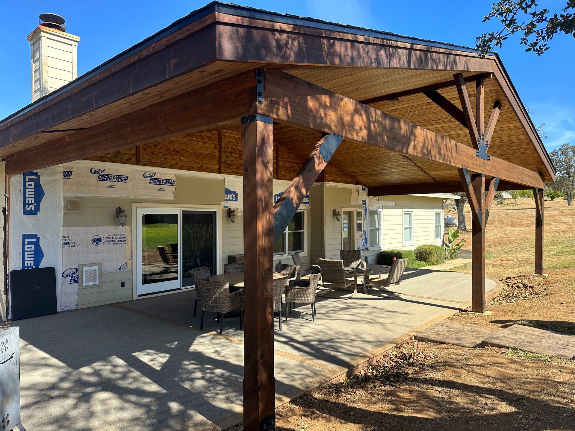 A house with a covered patio and a wooden roof.