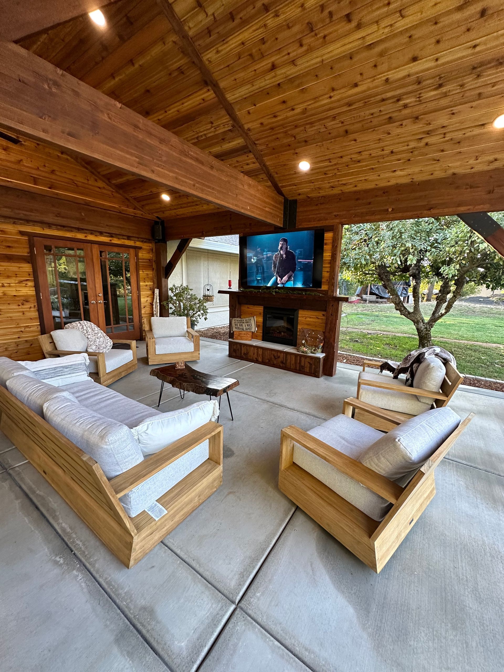 A living room with wooden furniture and a flat screen tv.