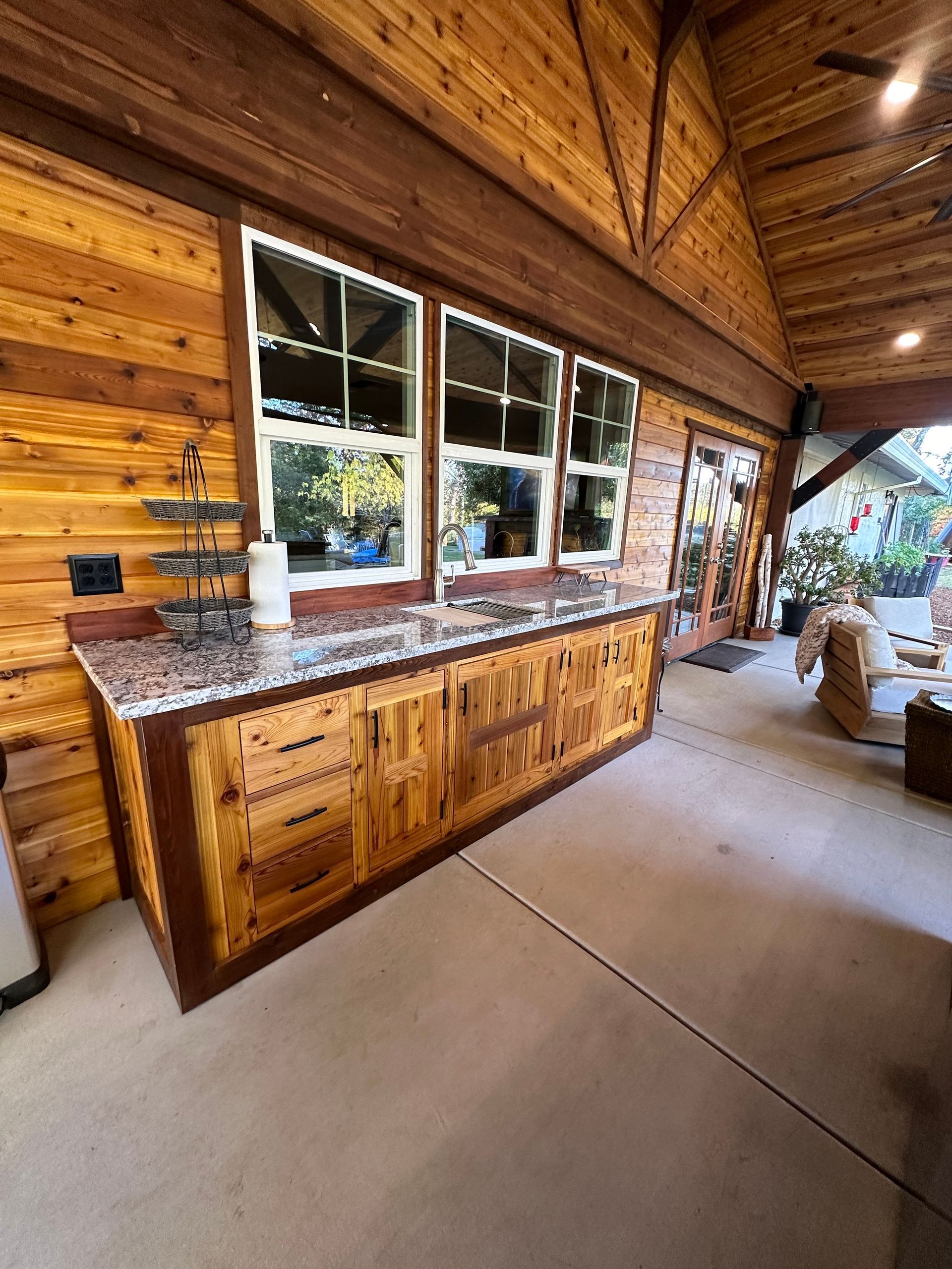 A kitchen with wooden cabinets and granite counter tops.
