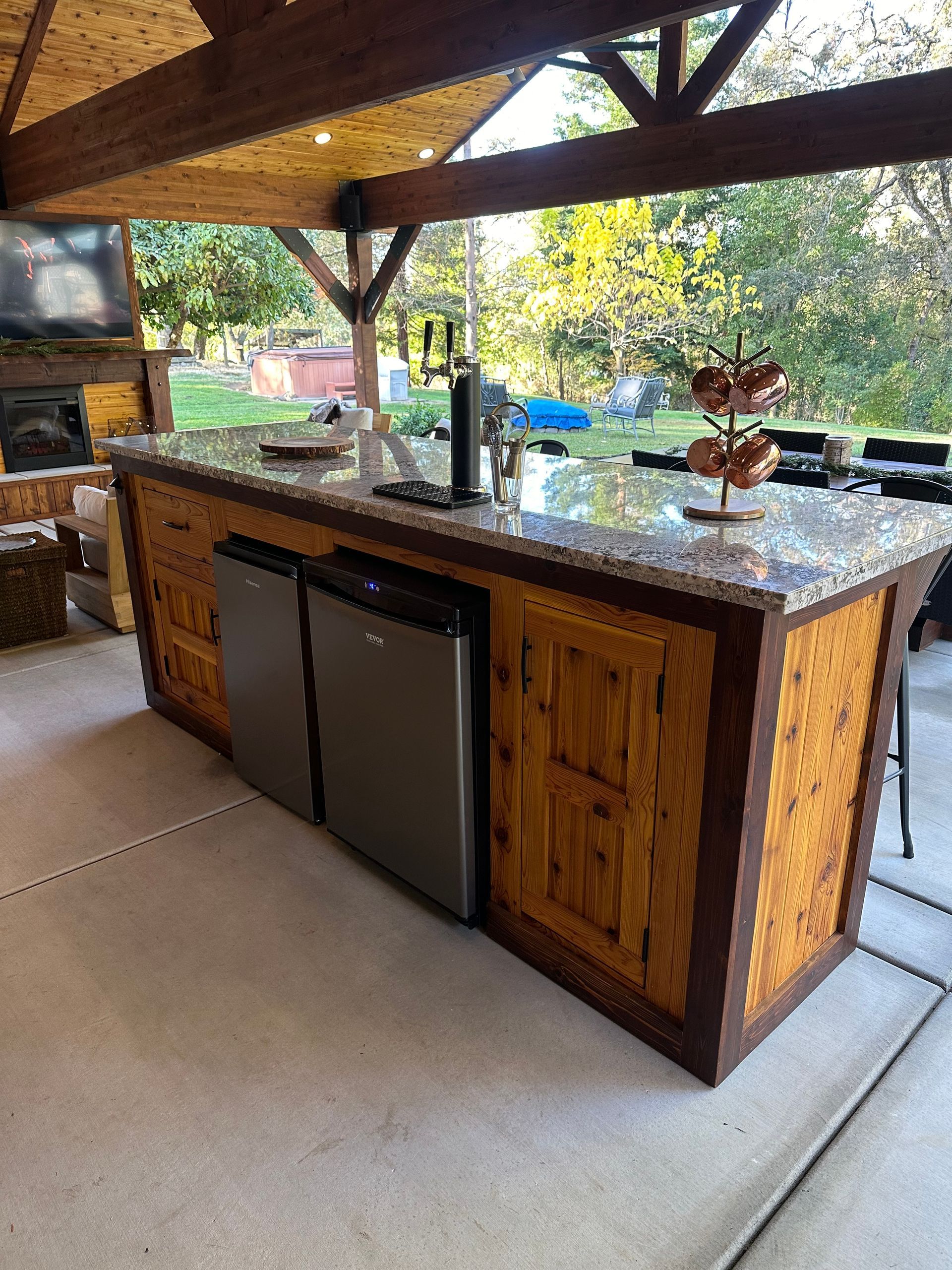 A large wooden kitchen island with a refrigerator and dishwasher.