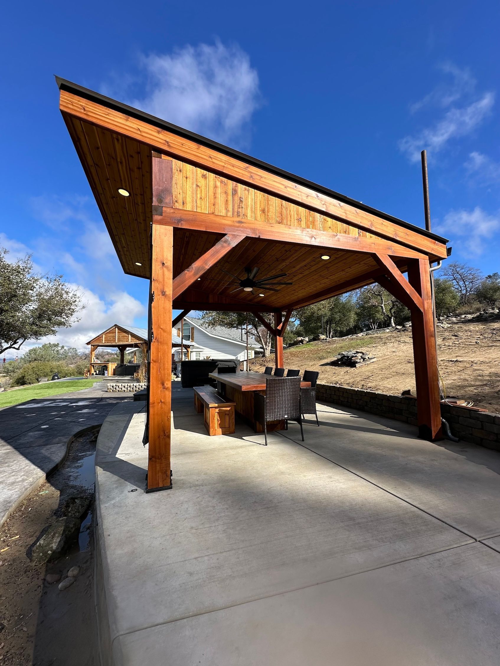 a wooden shelter with a screen on the side of it .