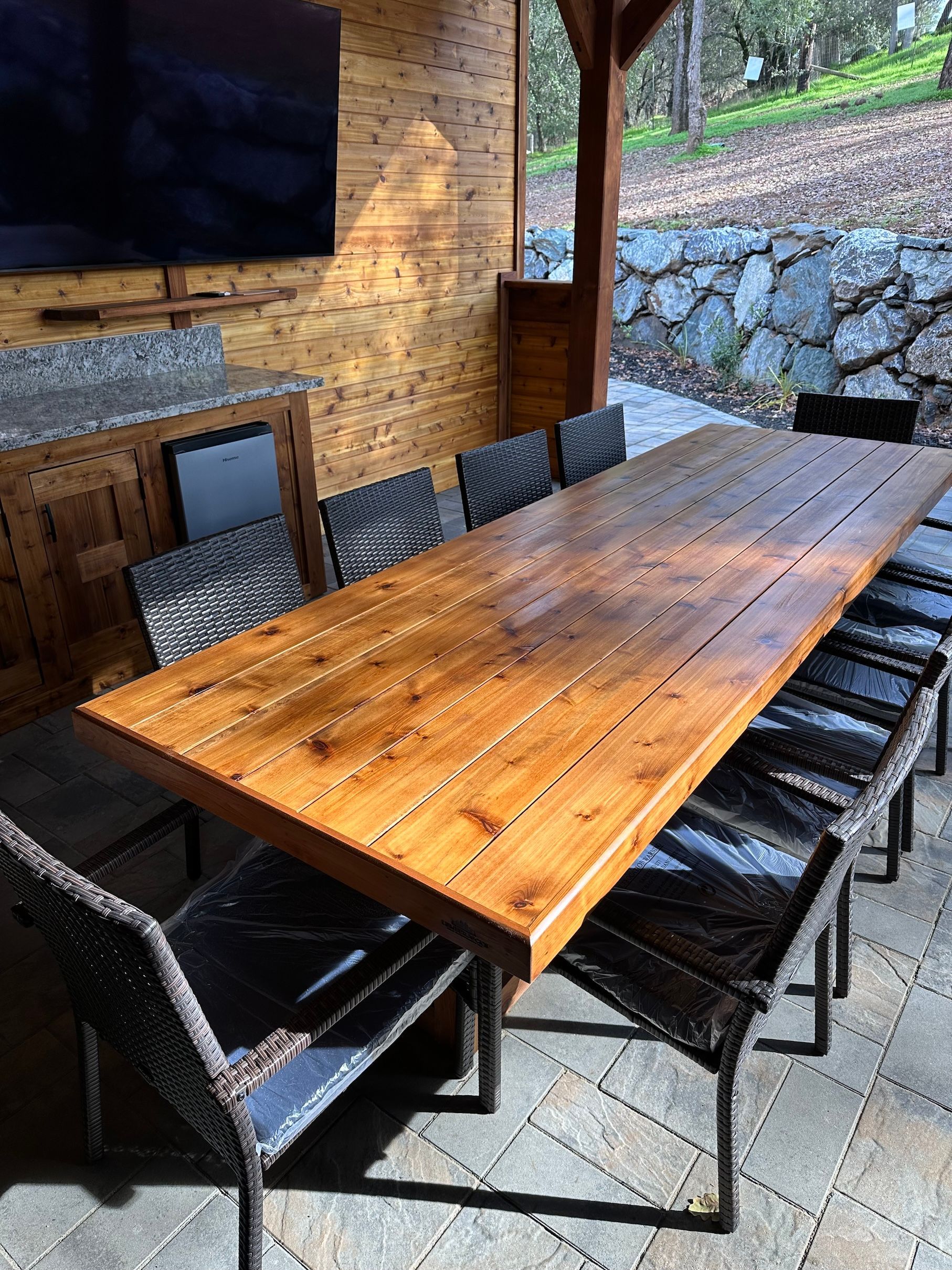 a wooden table and chairs are sitting on a patio .