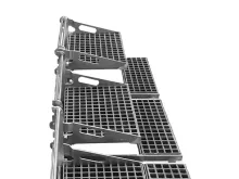 Metal grating stairs with a support structure, viewed from the side.
