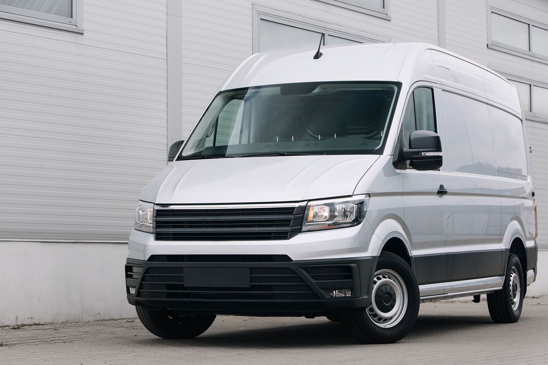 Modern cargo van near warehouse