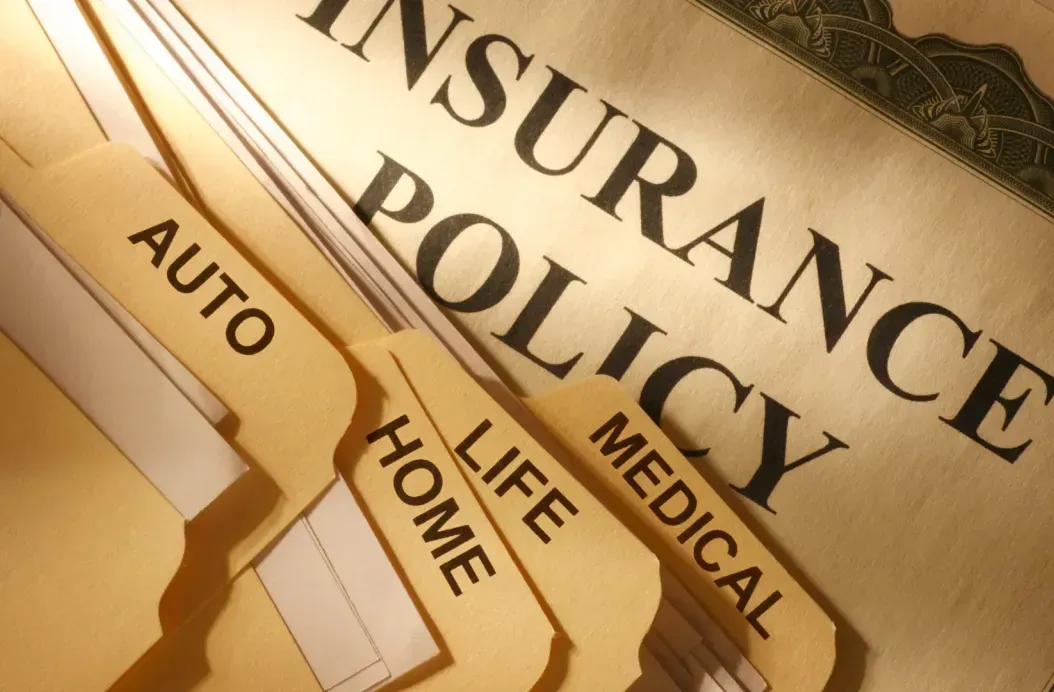 The word insurance is on a piece of paper