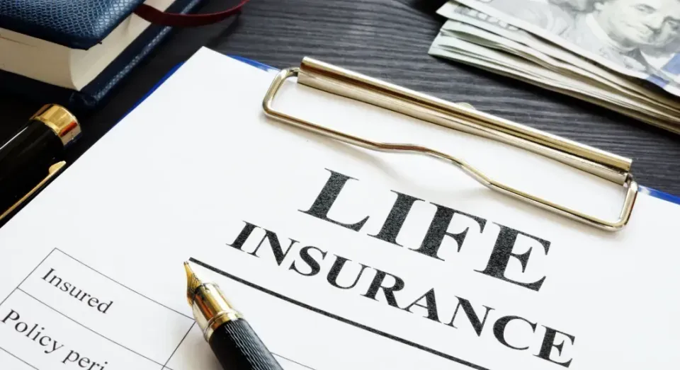 A clipboard with a pen and a stack of money on it.