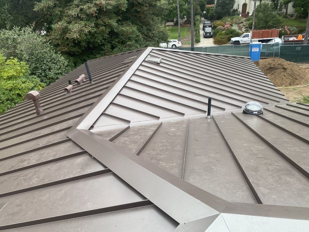 A brown roof with a skylight on it