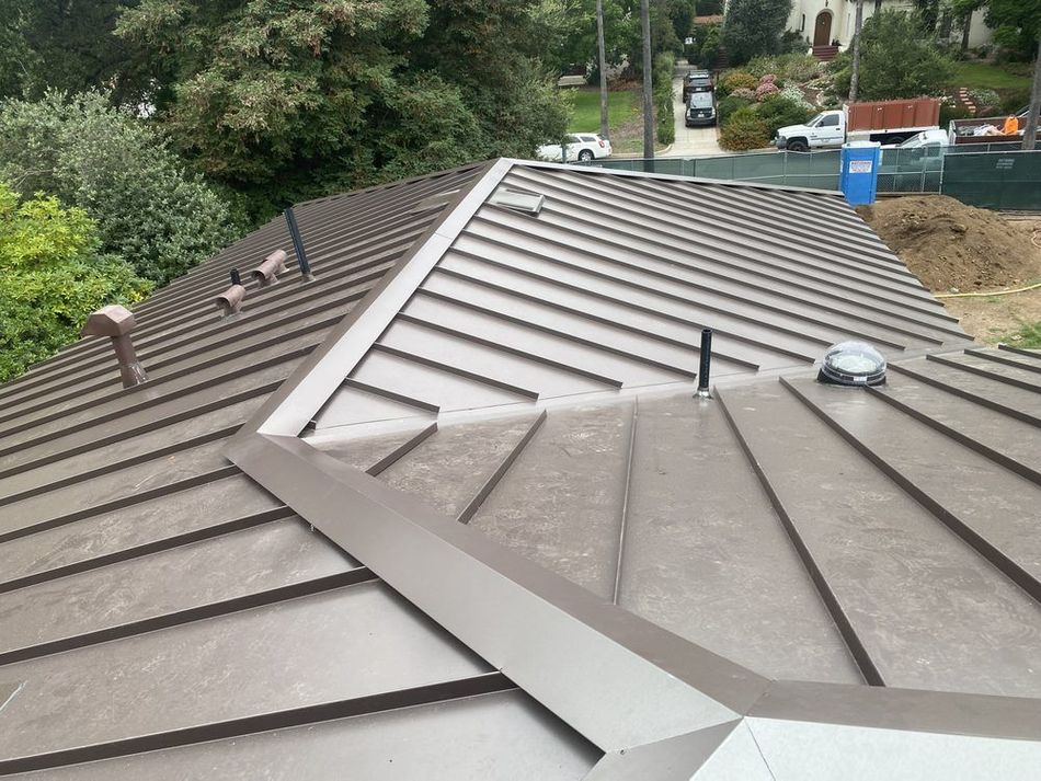 A brown roof with a skylight on it