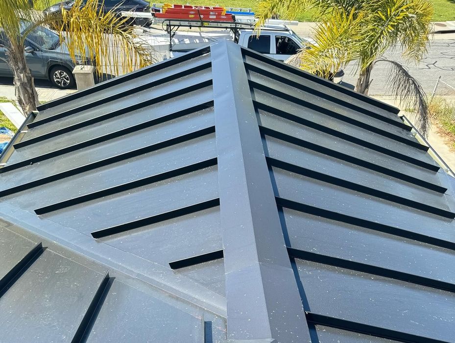 A close up of a metal roof with black stripes.