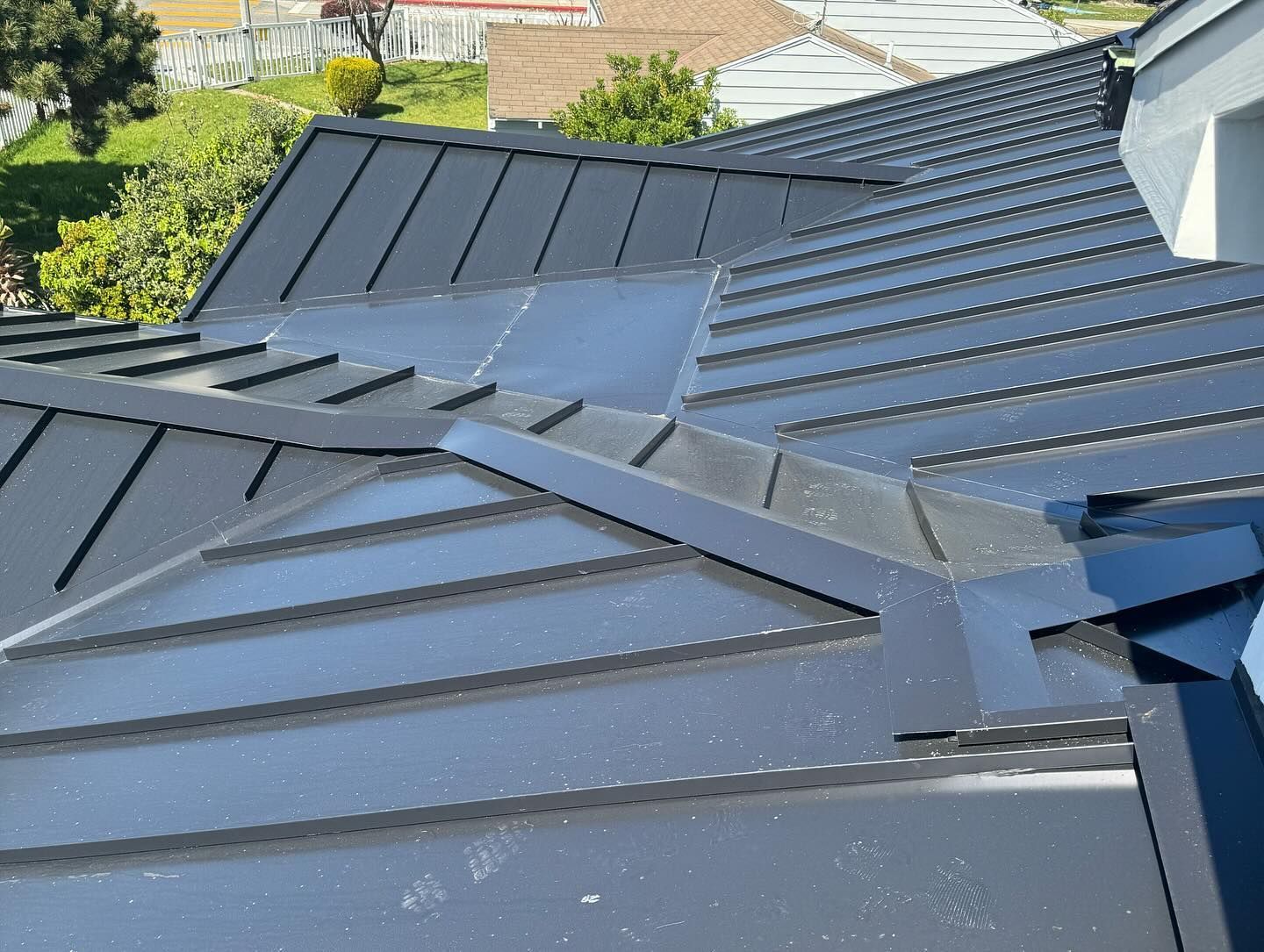 A close up of a black metal roof on a house.