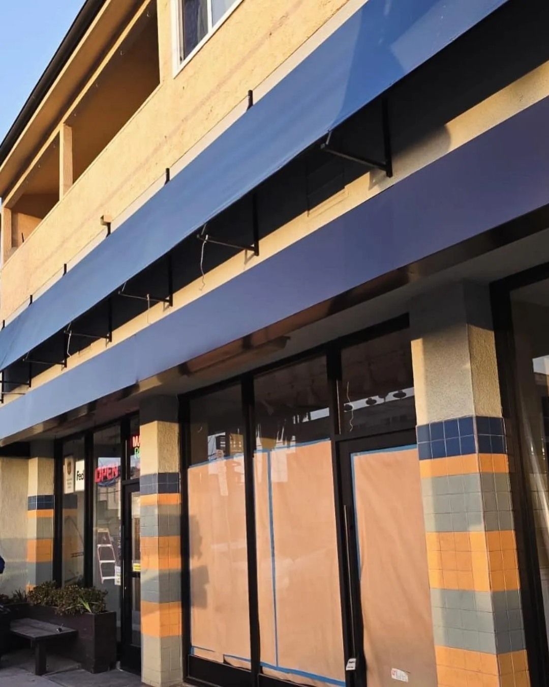 A building with a blue awning on top of it
