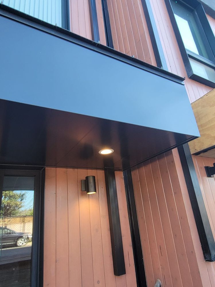 A building with a black awning over the front door