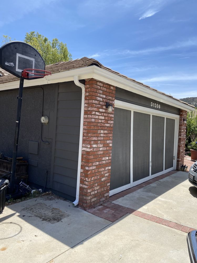 A garage with a basketball hoop on top of it.