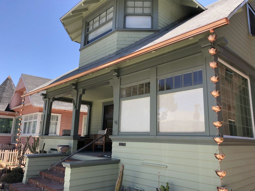 A house with a porch and copper gutters